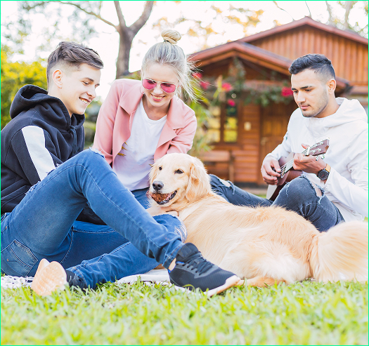 family in front of home on lawn with dog